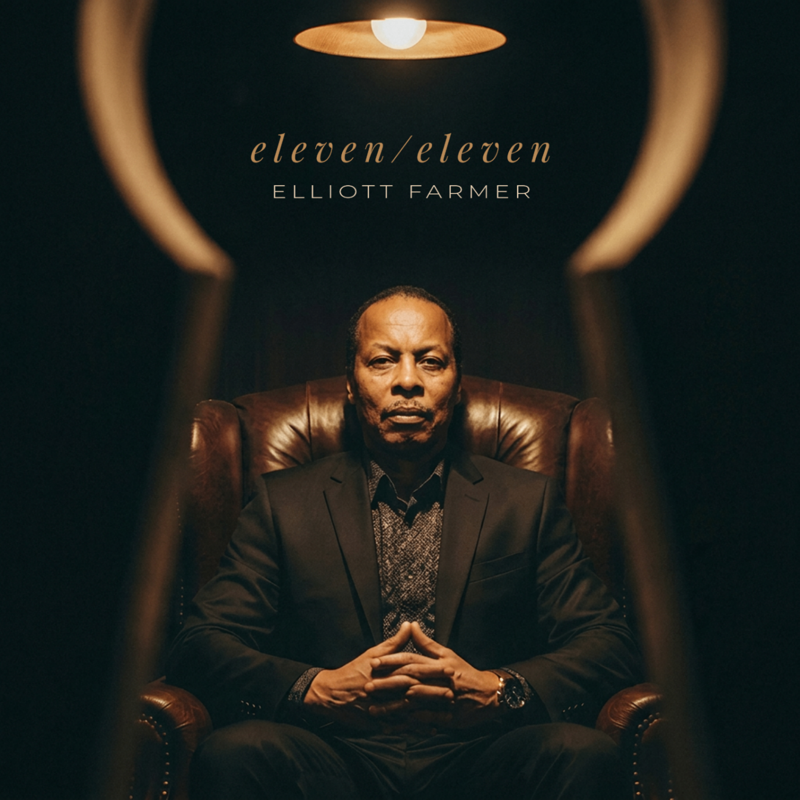 eleven/eleven album cover — Elliott Farmer seated beneath a warm pendant light
